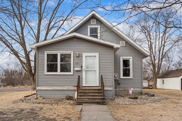 bungalow-style house with entry steps