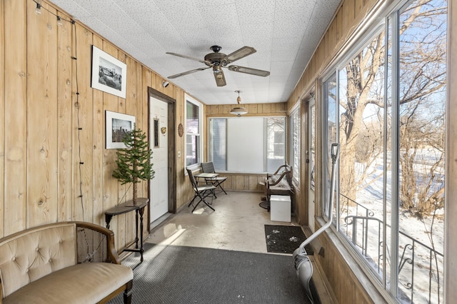 sunroom featuring a ceiling fan and a wealth of natural light