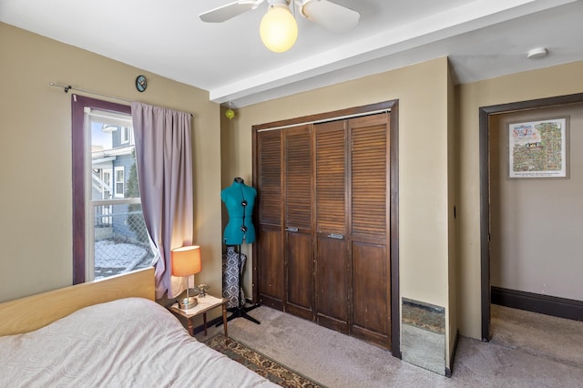 carpeted bedroom with a closet, a ceiling fan, and baseboards