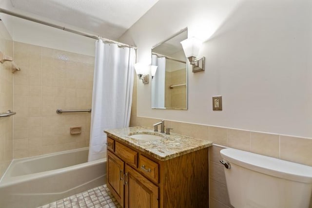 full bathroom featuring tile walls, shower / bathtub combination with curtain, vanity, and toilet