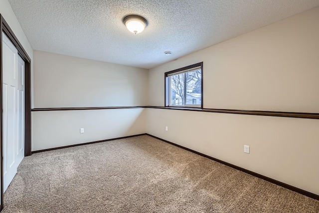 unfurnished bedroom with a textured ceiling, a closet, and carpet flooring