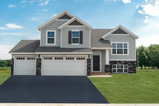 view of front of house with a front lawn and a garage