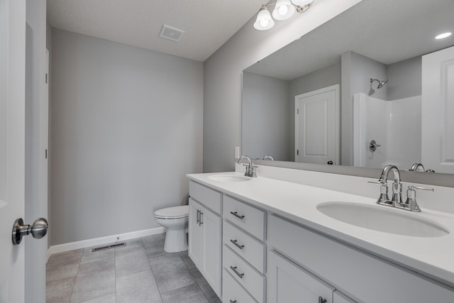 bathroom featuring toilet, a textured ceiling, walk in shower, and vanity