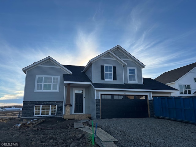 view of front of house with driveway, an attached garage, and fence