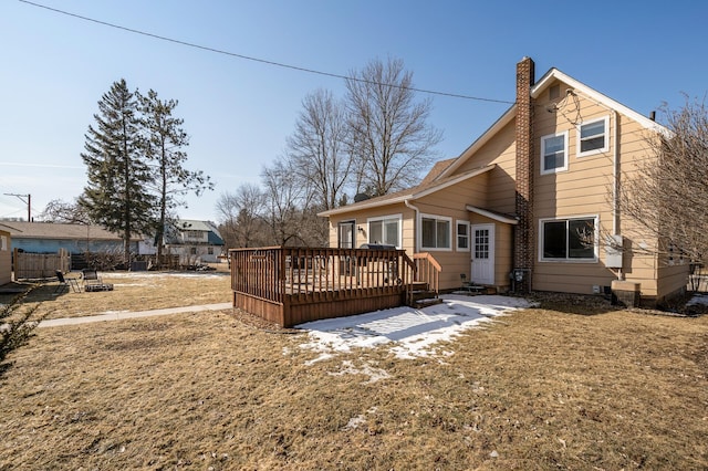 rear view of house featuring a deck and a chimney