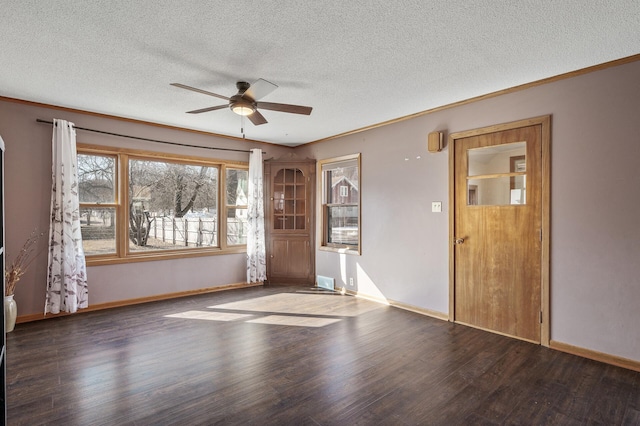 spare room featuring ornamental molding, baseboards, a ceiling fan, and wood finished floors