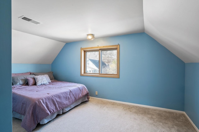 bedroom with visible vents, carpet floors, baseboards, and vaulted ceiling