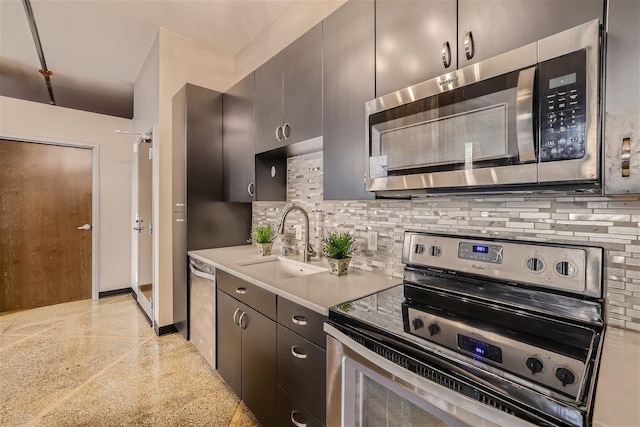 kitchen featuring stainless steel appliances, tasteful backsplash, and sink