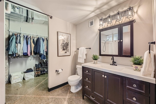 bathroom featuring toilet and vanity