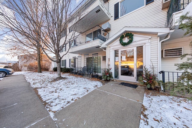 view of snow covered property entrance