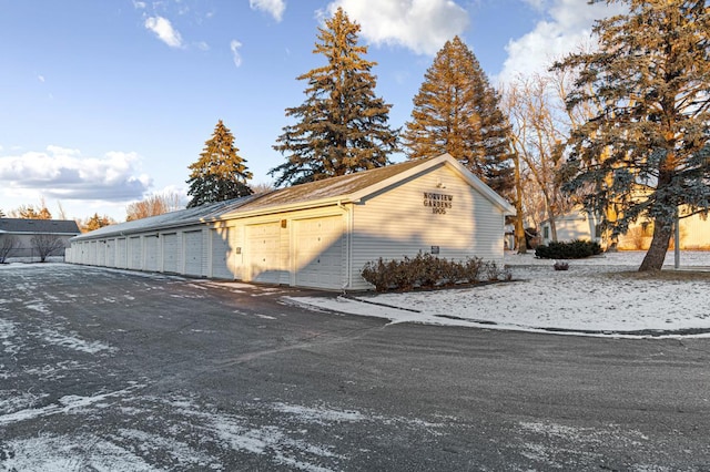 view of property exterior with a garage and an outbuilding