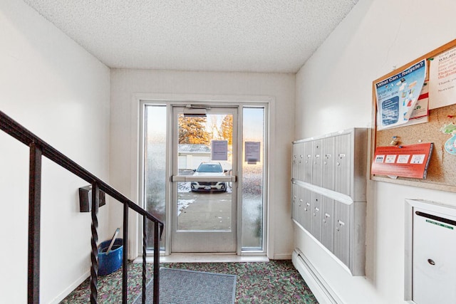 entryway with a textured ceiling and mail boxes