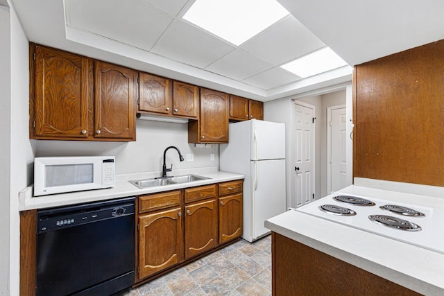 kitchen featuring white appliances and sink