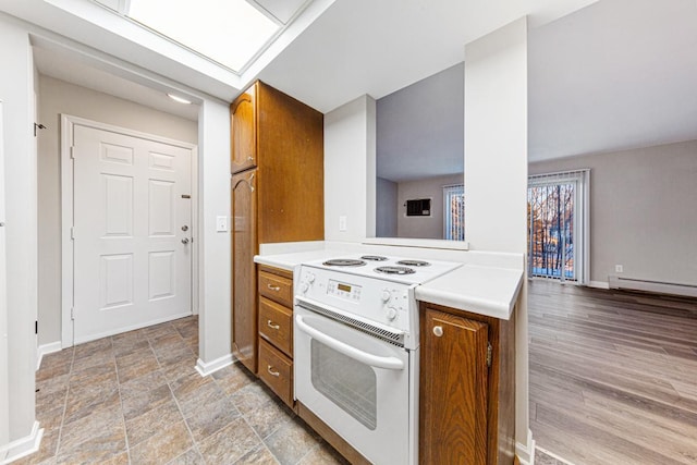 kitchen with a baseboard heating unit and electric stove