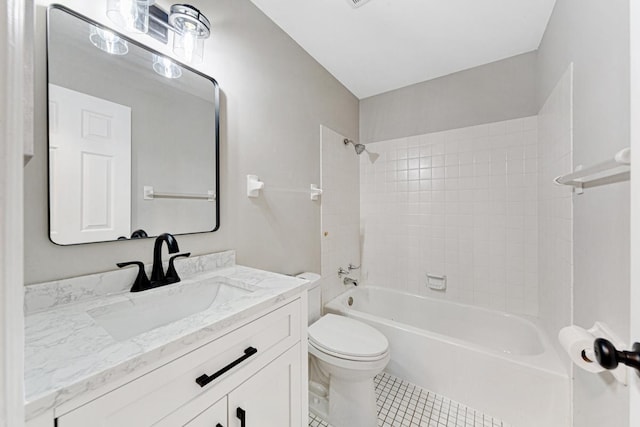 full bathroom with tiled shower / bath, tile patterned floors, vanity, and toilet