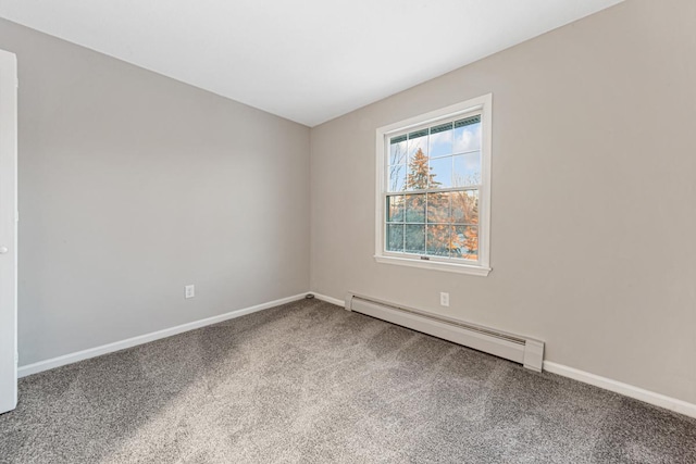 empty room featuring baseboard heating and carpet