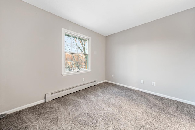 spare room with a baseboard radiator and carpet