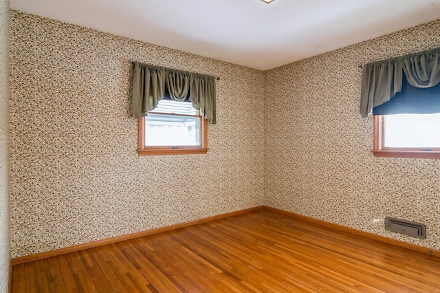 empty room with wood-type flooring