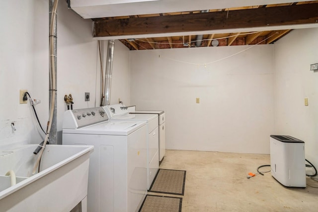 washroom featuring washer and dryer and sink