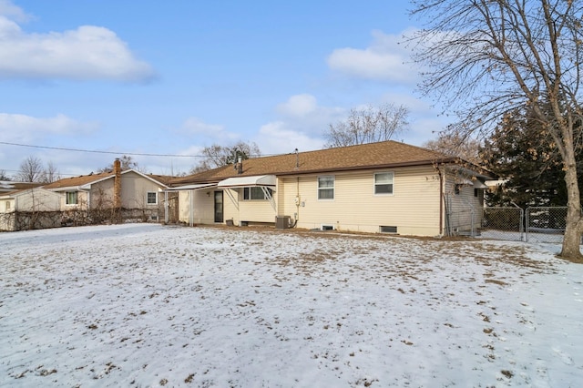 snow covered property with cooling unit