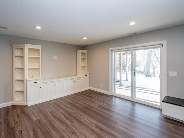 unfurnished living room featuring dark wood-type flooring