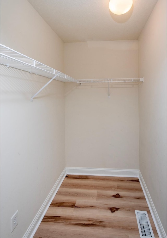 walk in closet featuring hardwood / wood-style floors