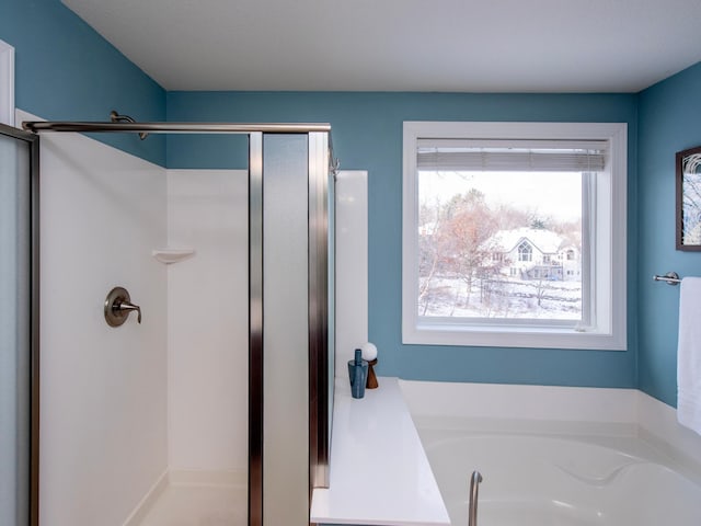 bathroom featuring plus walk in shower