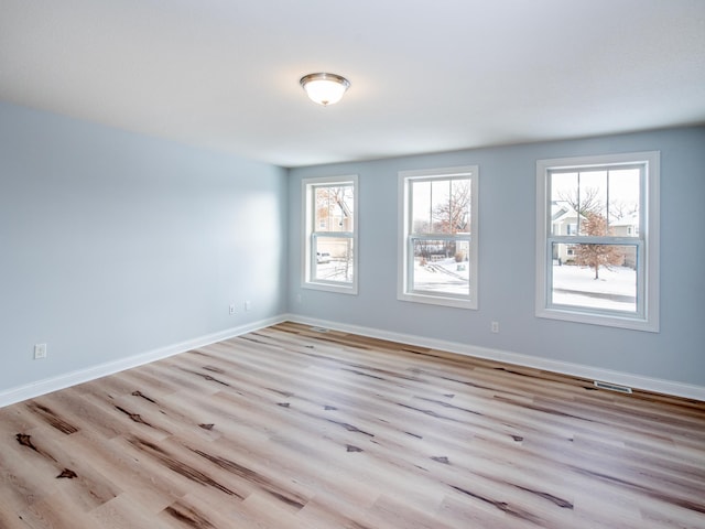 spare room with light wood-type flooring