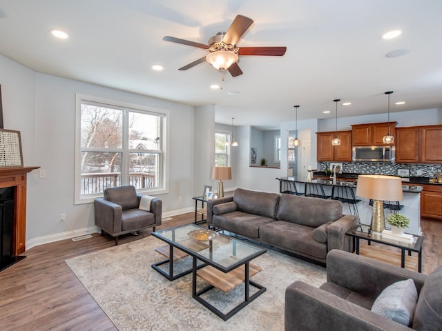 living room featuring ceiling fan and light wood-type flooring