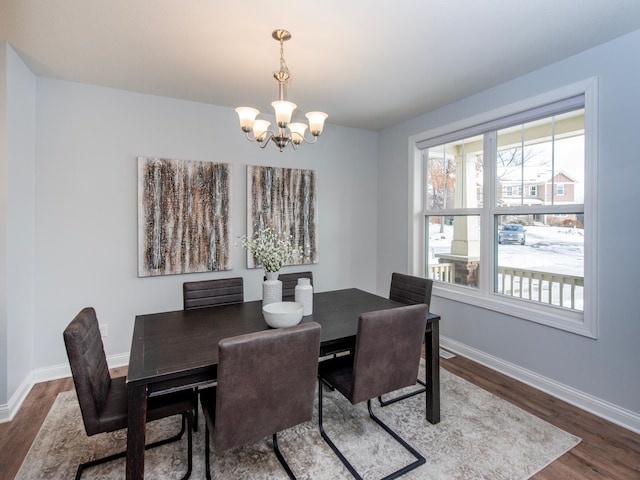 dining space with plenty of natural light, a chandelier, and hardwood / wood-style floors