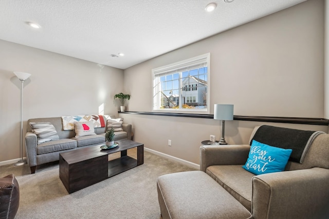 carpeted living room featuring a textured ceiling