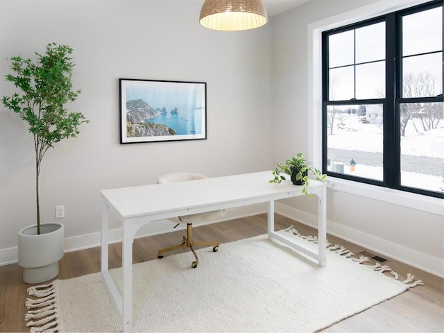 office with baseboards and wood finished floors