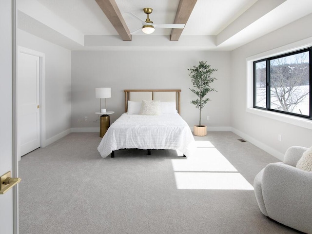 bedroom with carpet floors, beamed ceiling, visible vents, and baseboards