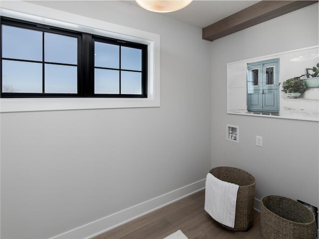 living area featuring baseboards and wood finished floors