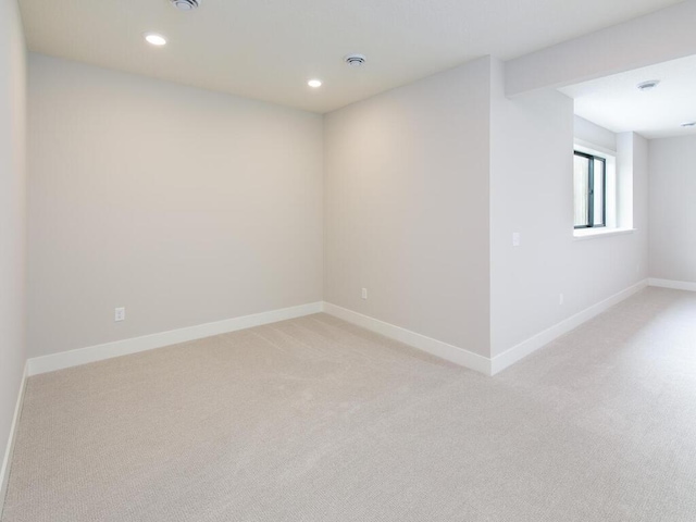 empty room featuring baseboards, light colored carpet, and recessed lighting