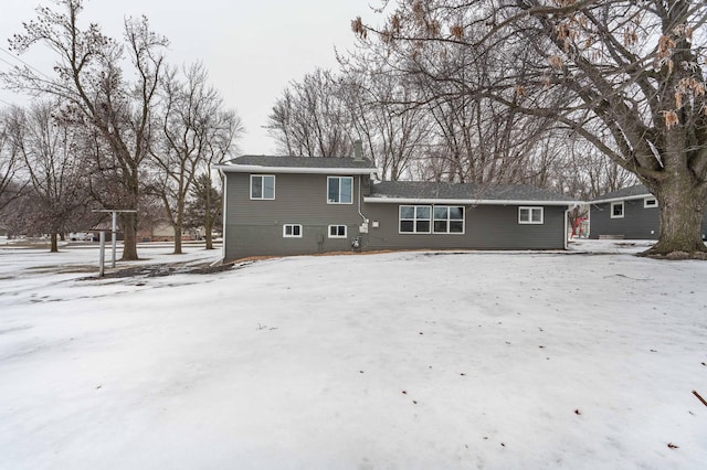 view of snow covered rear of property