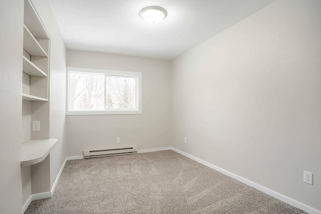 spare room featuring a baseboard radiator and carpet floors