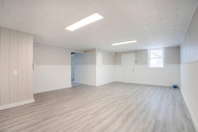 basement with light hardwood / wood-style flooring