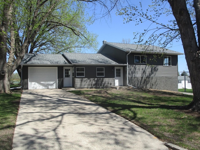 53 Eastview Dr, Hancock, MN 56244 - view of front of house featuring a garage, driveway, a front lawn, and a shingled roof