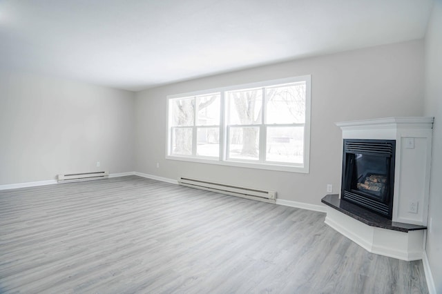 53 Eastview Dr, Hancock, MN 56244 - unfurnished living room with a baseboard radiator, wood finished floors, a glass covered fireplace, and baseboards