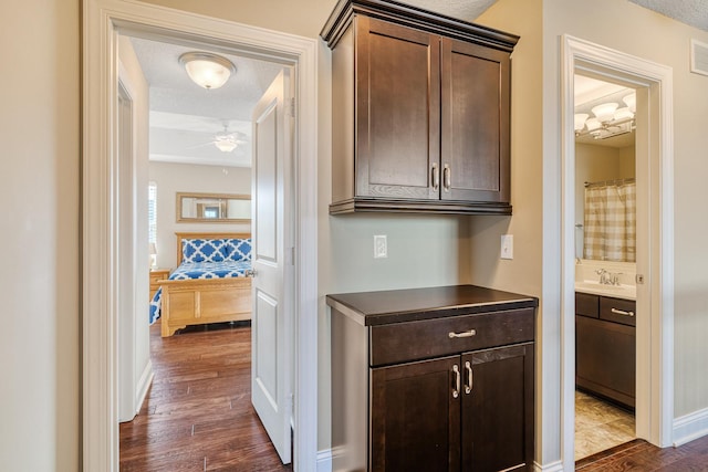 interior space with dark hardwood / wood-style floors, sink, and a textured ceiling