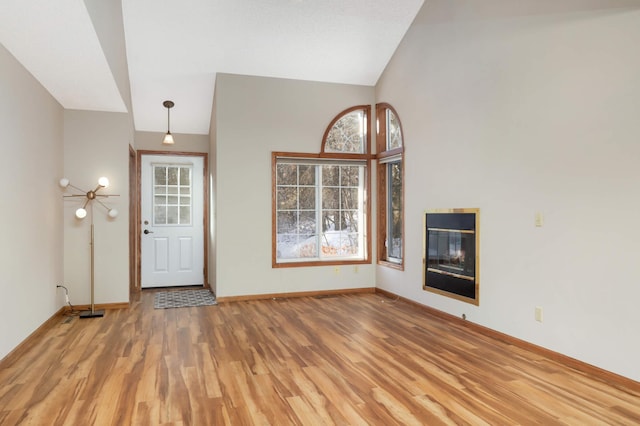 entryway featuring light hardwood / wood-style floors and vaulted ceiling