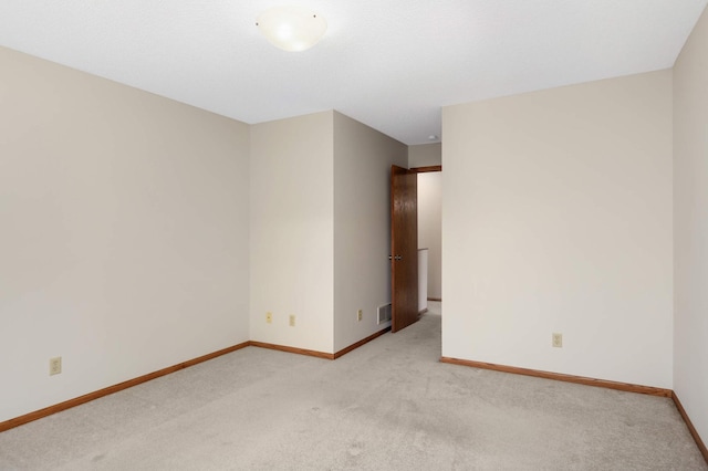 unfurnished room with light carpet