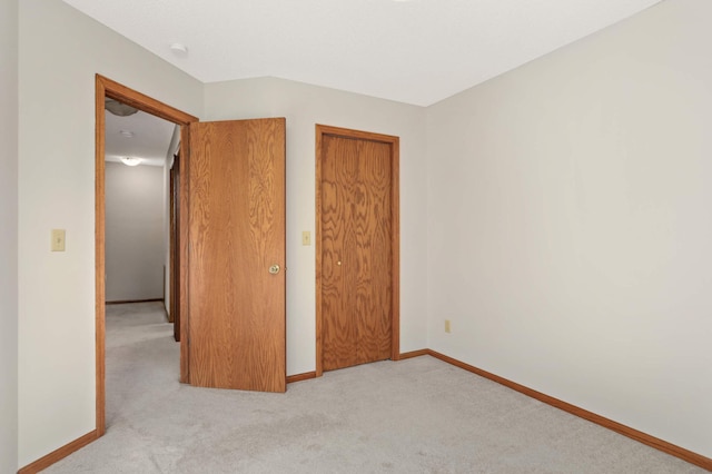 unfurnished bedroom with light colored carpet