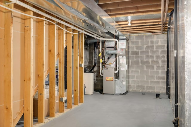 basement featuring water heater and heating unit