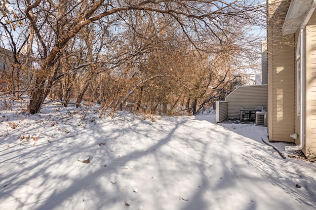 yard layered in snow featuring central AC