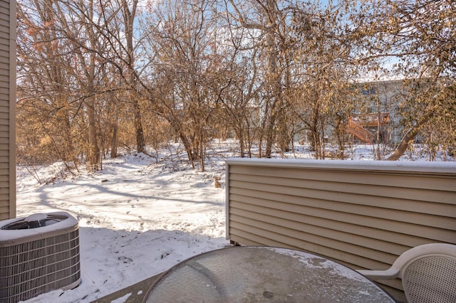 snow covered patio with central air condition unit