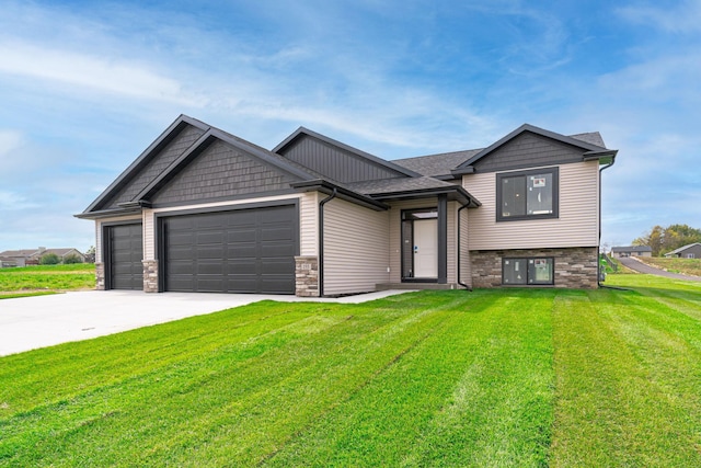 view of front of home with a garage and a front lawn