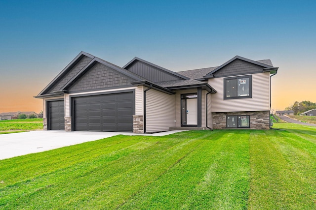 view of front of property with a yard and a garage