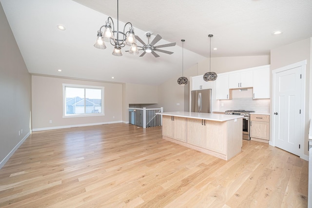 kitchen with stainless steel appliances, white cabinets, a center island, a breakfast bar area, and backsplash